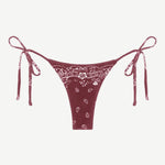 Praia Bottom—maroon bikini bottom with a white paisley bandana print, crafted from eco terry fabric and featuring adjustable side tie straps—displayed on a white background.