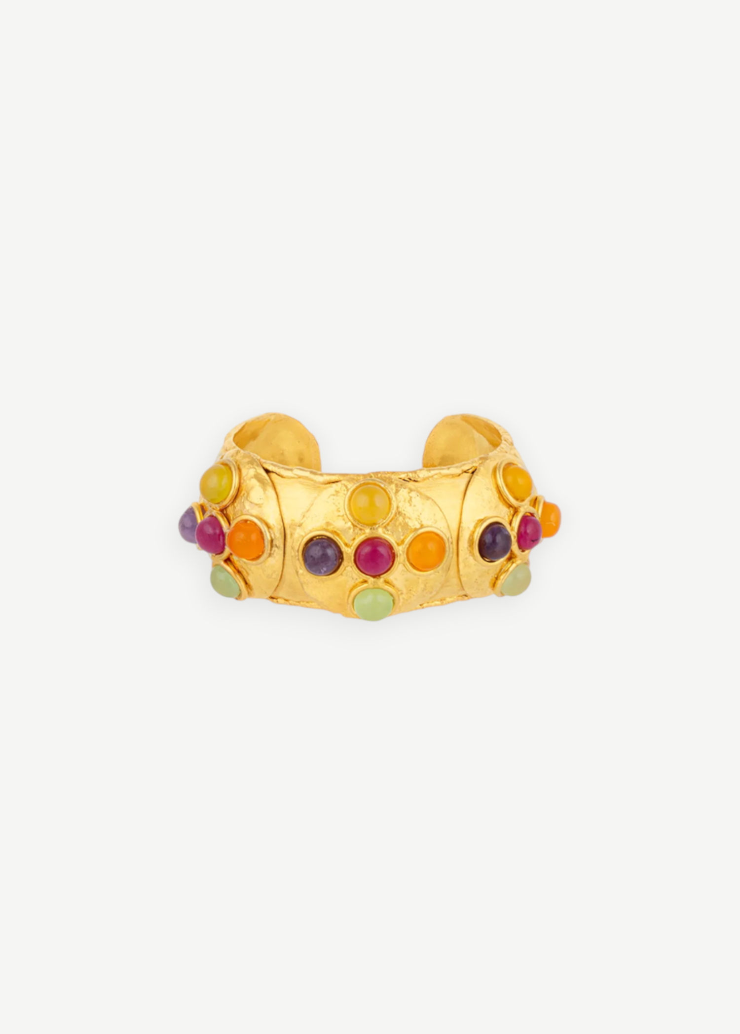 Introducing the Theodora Cuff: a wide gold ring with a gently pointed front, this handcrafted piece is adorned with small, colorful round gemstones—including red, green, purple, and orange—set against a simple white backdrop. Effortlessly wearable, the Theodora Cuff brings vibrant elegance to any ensemble.