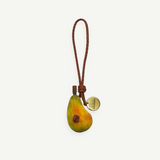 KABE SHOP INC pear-shaped wooden bag charm with a braided leather strap and a gold-tone branded metal tag.