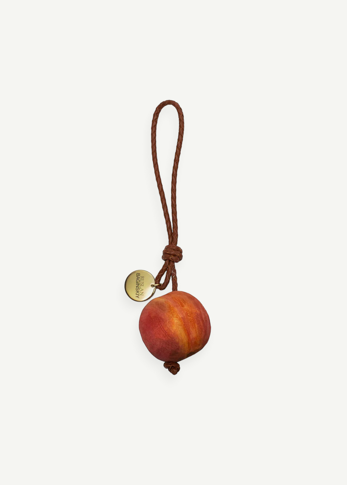 KABE SHOP INC peach-shaped wooden bag charm with a braided brown leather strap and a gold-tone metal logo tag.