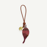 KABE SHOP INC beetroot-shaped bag charm with a braided brown leather strap and a small gold-toned branded metal tag.