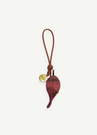 KABE SHOP INC beetroot-shaped bag charm with a braided brown leather strap and a small gold-toned branded metal tag.