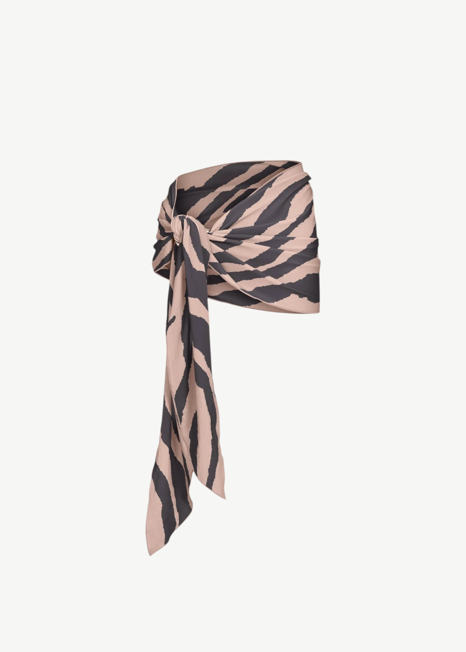 The Souk Skirt, featuring beige and black stripes, is wrapped and knotted at the waist as it drapes elegantly to one side against a plain white background.