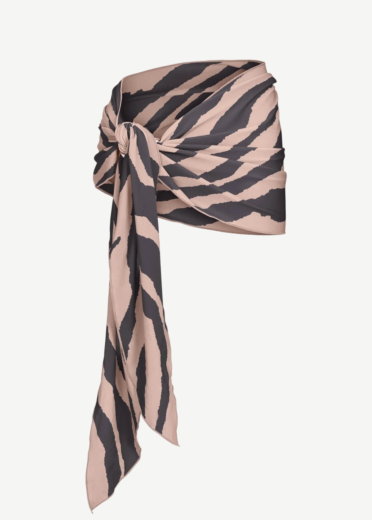 The Souk Skirt, featuring beige and black stripes, is wrapped and knotted at the waist as it drapes elegantly to one side against a plain white background.