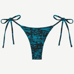 Praia Bottom in blue and black tiger print, an adjustable tie bikini bottom crafted from recycled polyamide for eco-friendly swimwear, displayed on a white background.