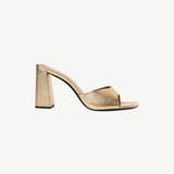 Sloane Heel gold slide sandal with a wide front strap and a chunky block heel in a sophisticated, timeless silhouette.