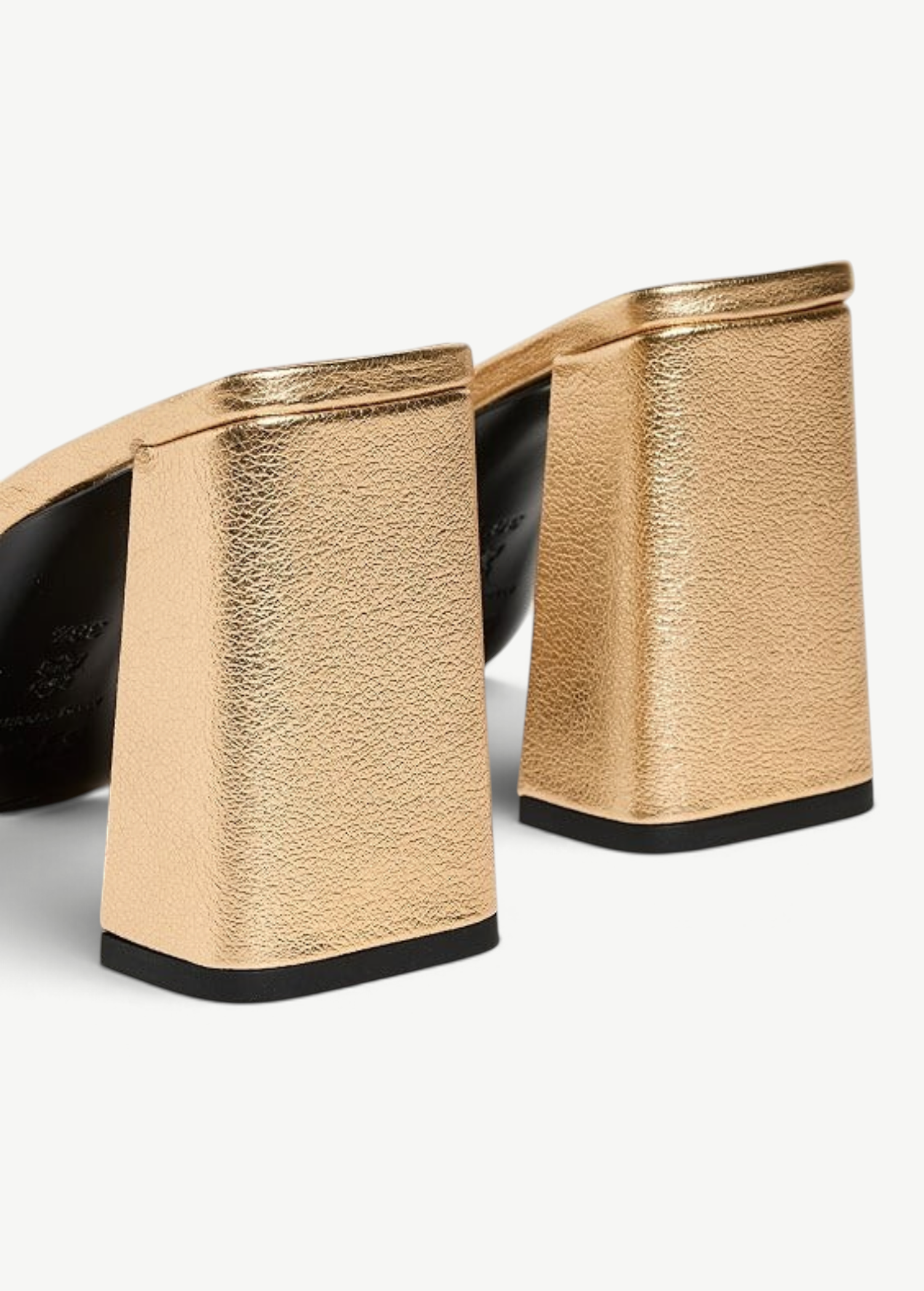 Sloane Heel metallic gold mules with block heels and black outsoles in a timeless silhouette.