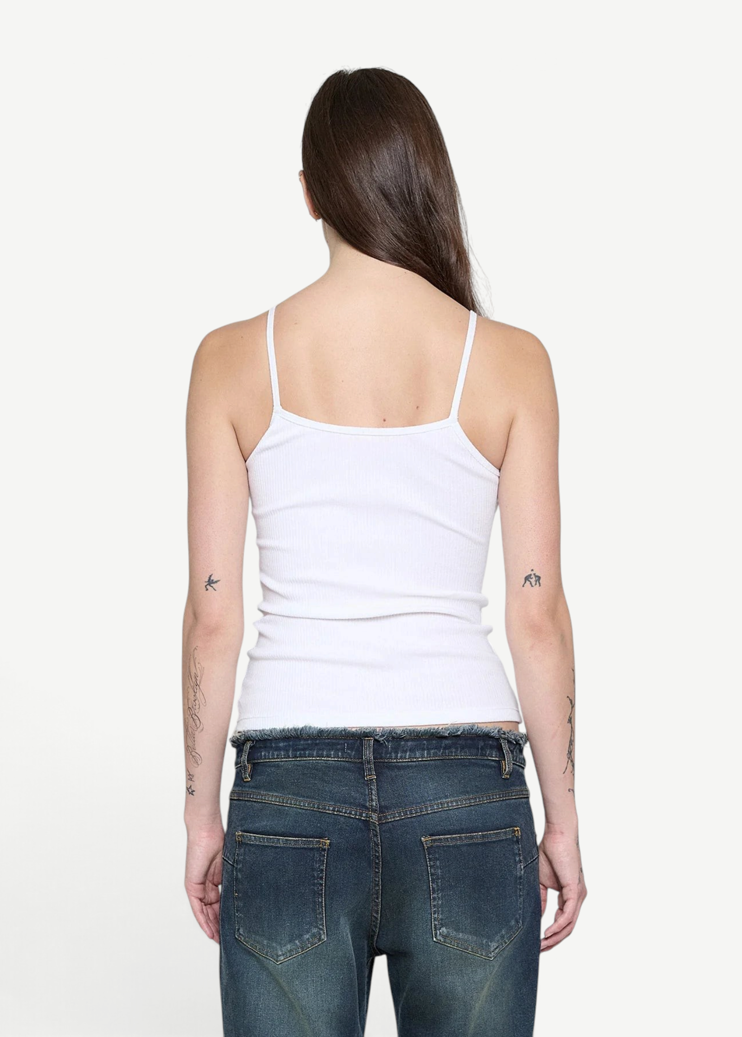 Back view of a woman wearing a white KABE SHOP INC ribbed cami top with thin straps and a fitted silhouette.