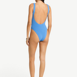 KABE SHOP INC Mara blue textured one-piece swimsuit with a low scoop back and high-cut leg on a model