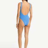 KABE SHOP INC Mara blue textured one-piece swimsuit with a low scoop back and high-cut leg on a model