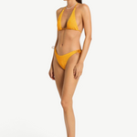 Model wearing KABE SHOP INC yellow textured bikini bottom with side loop tie detail, side view