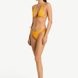 Model wearing KABE SHOP INC yellow textured bikini bottom with side loop tie detail, side view
