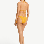 Model wearing KABE SHOP INC yellow textured Sonali bikini briefs with side loop ties, back view.
