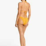 Model wearing KABE SHOP INC yellow textured Sonali bikini briefs with side loop ties, back view.