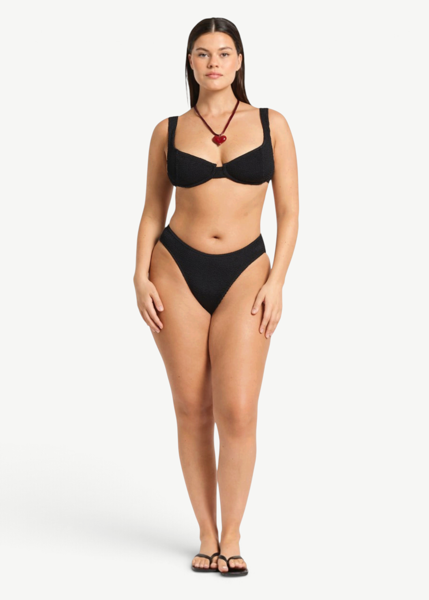 Model wearing KABE SHOP INC Olivia black high-cut bikini briefs in shimmer crinkle fabric with full coverage.