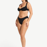 Model wearing KABE SHOP INC Olivia black high-cut bikini brief in shimmer crinkle fabric with full coverage