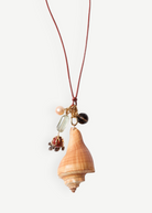 KABE SHOP INC shell necklace featuring a natural conch shell, colorful stone charms, and adjustable leather cord.