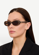 KABE SHOP INC Jacquemus Nuvola sunglasses with metallic brown oval acetate frames and brown lenses on a model