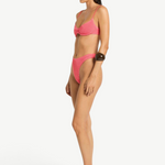 Model wearing KABE SHOP INC Gracie Balconette pink textured bikini set in a side profile view