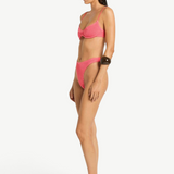 Model wearing KABE SHOP INC Gracie Balconette pink textured bikini set in a side profile view