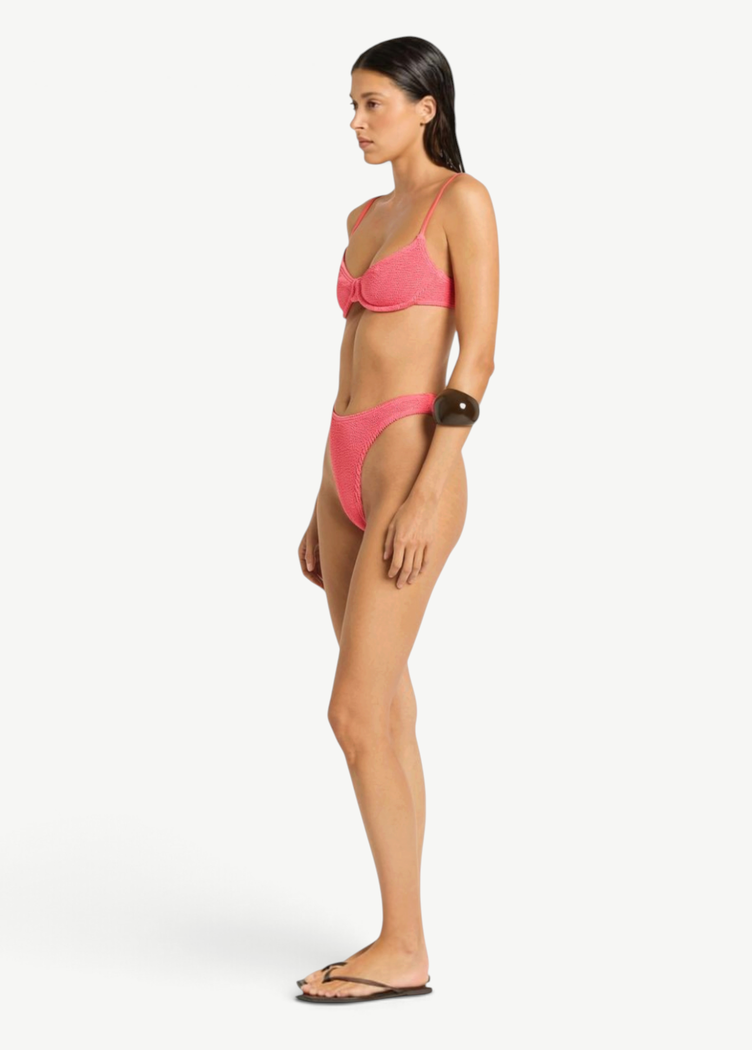 Model wearing KABE SHOP INC Gracie Balconette pink textured bikini set in a side profile view