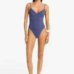 Model wearing a blue Alana underwire one-piece swimsuit by KABE SHOP INC with a sleek, supportive second-skin fit.