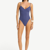 Model wearing a blue Alana underwire one-piece swimsuit by KABE SHOP INC with a sleek, supportive second-skin fit.