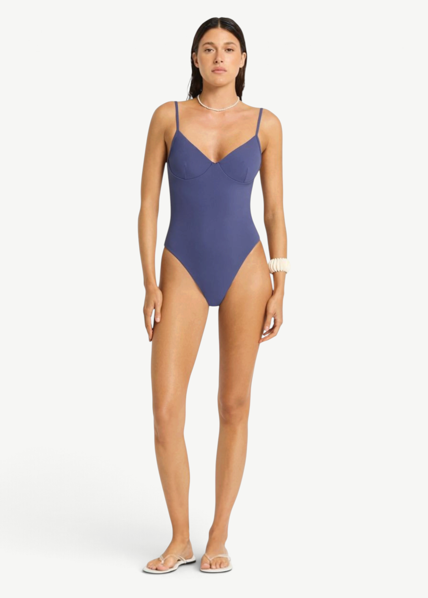 Model wearing a blue Alana underwire one-piece swimsuit by KABE SHOP INC with a sleek, supportive second-skin fit.