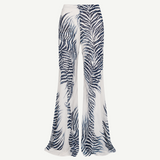High-waisted, wide-leg Luma Trouser in white with a dark blue palm leaf print, crafted from lightweight viscose georgette.