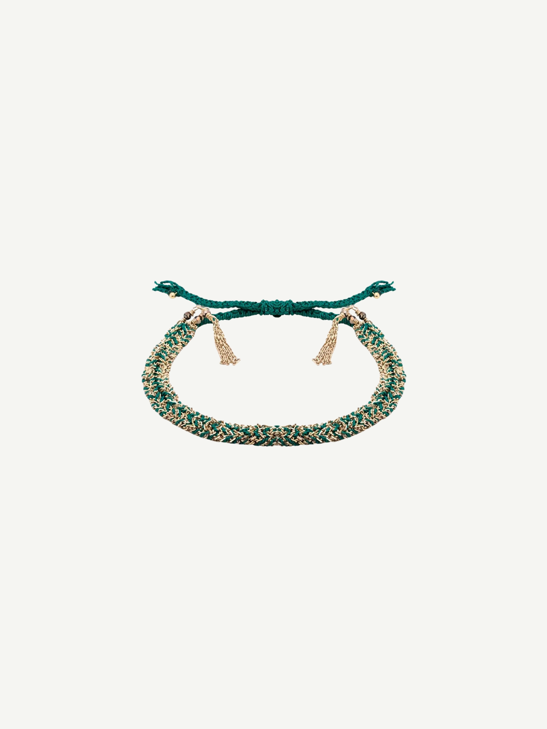 The N° 183 Braided Bracelet is a green and gold friendship bracelet with adjustable ties and gold tassel accents, featuring a yellow gold finish, displayed on a white background.
