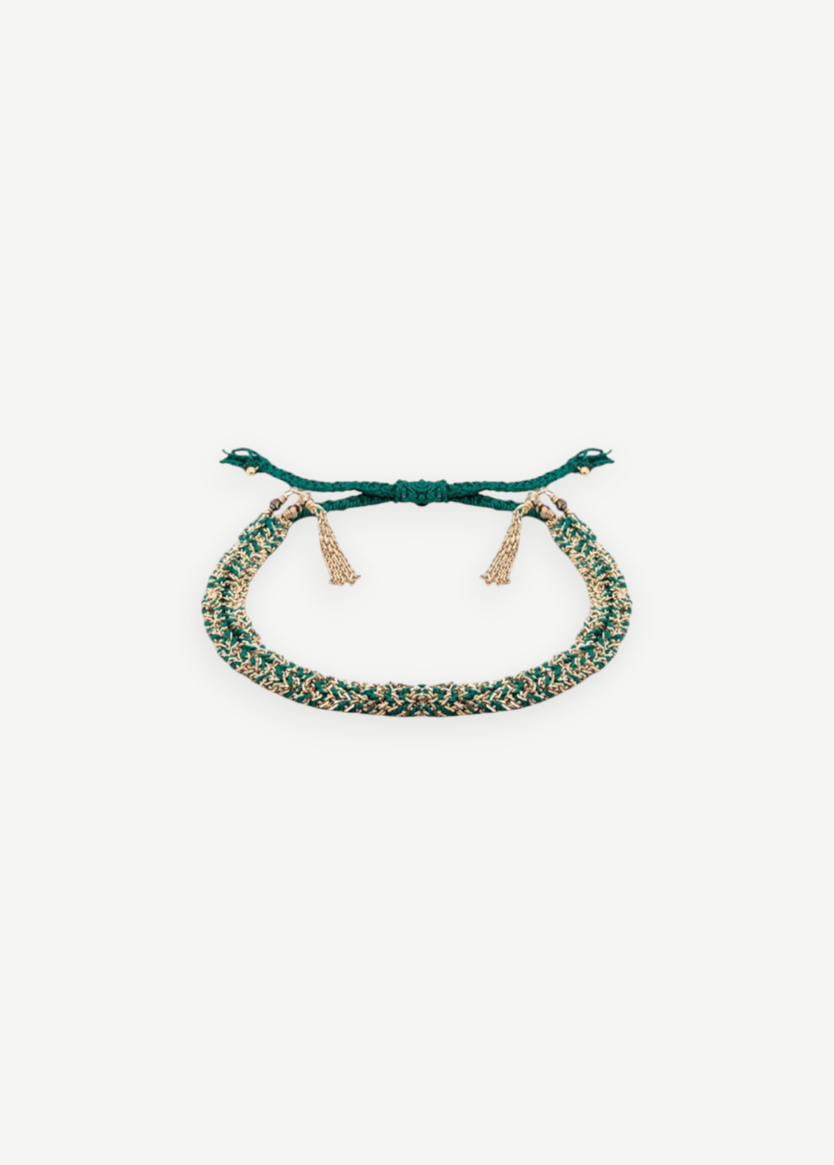 The N° 183 Braided Bracelet is a green and gold friendship bracelet with adjustable ties and gold tassel accents, featuring a yellow gold finish, displayed on a white background.