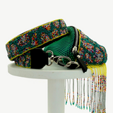 KABE SHOP INC Verdi bag featuring intricate green beaded patterns, a wide strap, and long decorative fringe tassels.