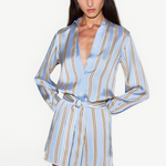 KABE SHOP INC Formentera romper in light blue with vertical brown stripes, collared neckline, and self-tie waist.