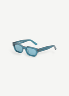 KABE Zed sunglasses featuring a retro wraparound silhouette in a translucent blue matte finish.