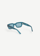KABE Zed sunglasses in translucent blue with a retro wraparound frame design and unique raw finish.