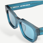 KABE Zed sunglasses featuring a translucent teal blue frame and retro wraparound silhouette