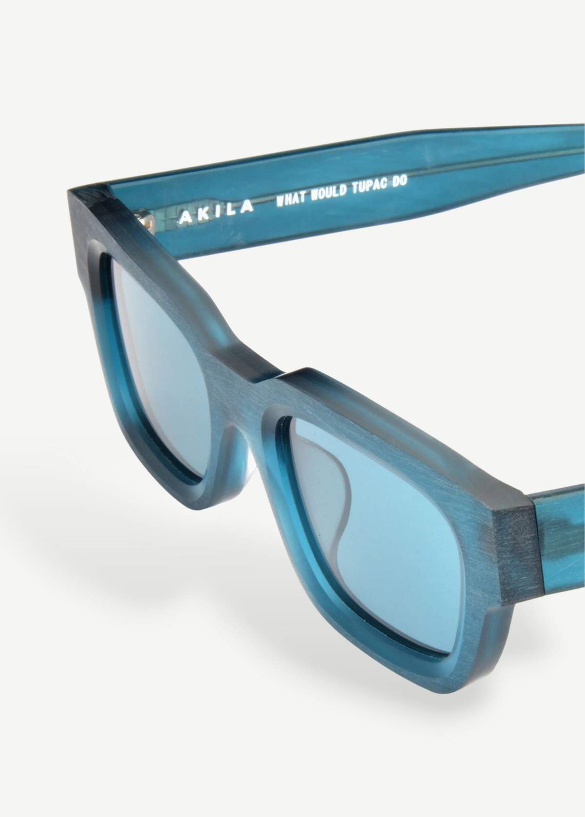 KABE Zed sunglasses featuring a translucent teal blue frame and retro wraparound silhouette